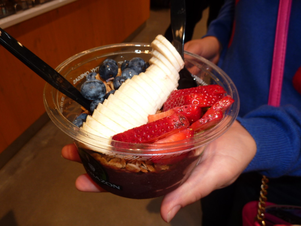 Acai bowl topped with granola, berries and bananas. 