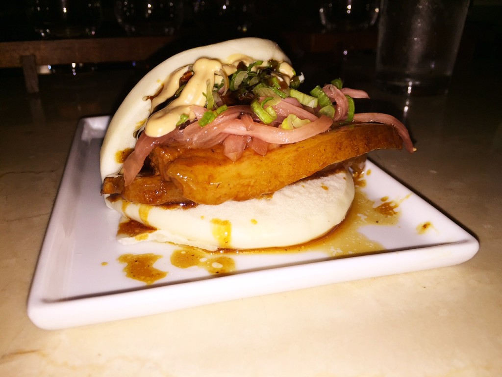 The Kush pork bun with marinated pork belly, pickled onion, and sesame mayo.