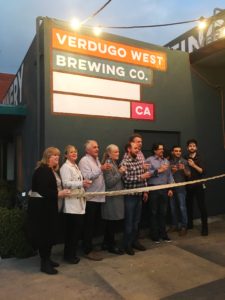 The whole staff lines up to prepare to cut the ribbon